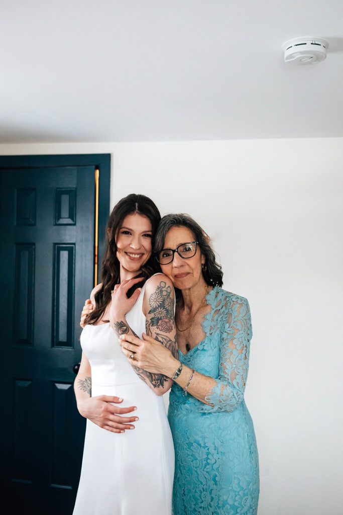 Bride and mother share a warm embrace before the wedding at The Arnold House.