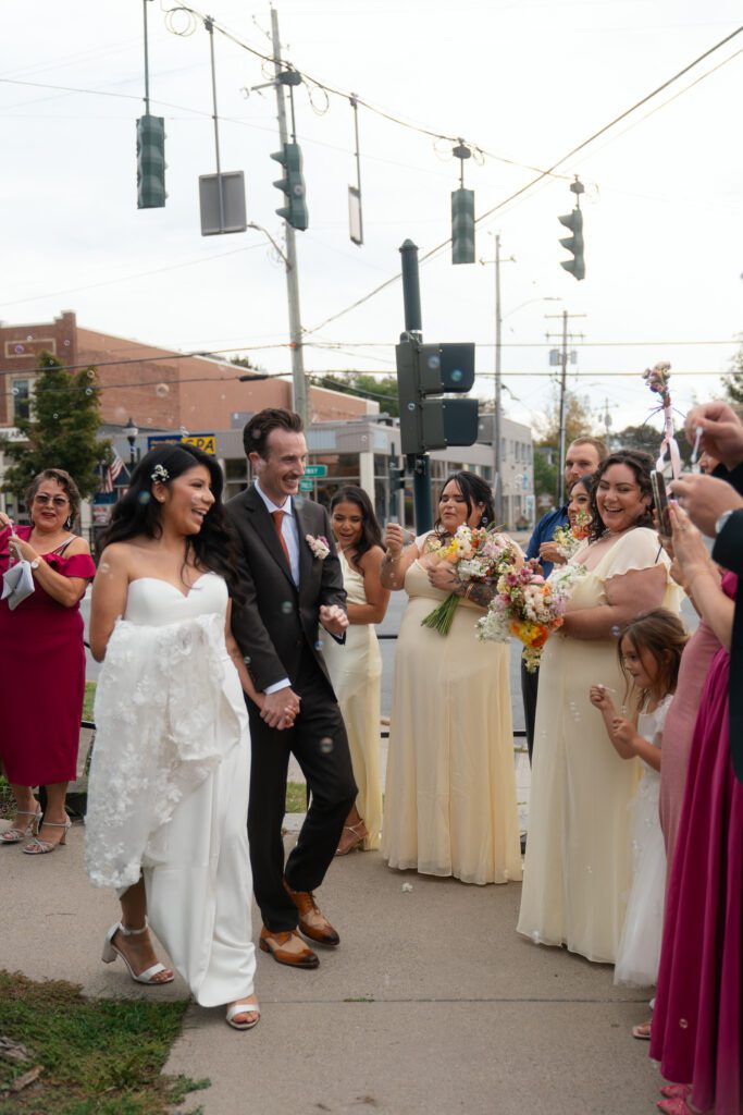 bride and groom leaving wedding ceremony at st peter's church in liberty