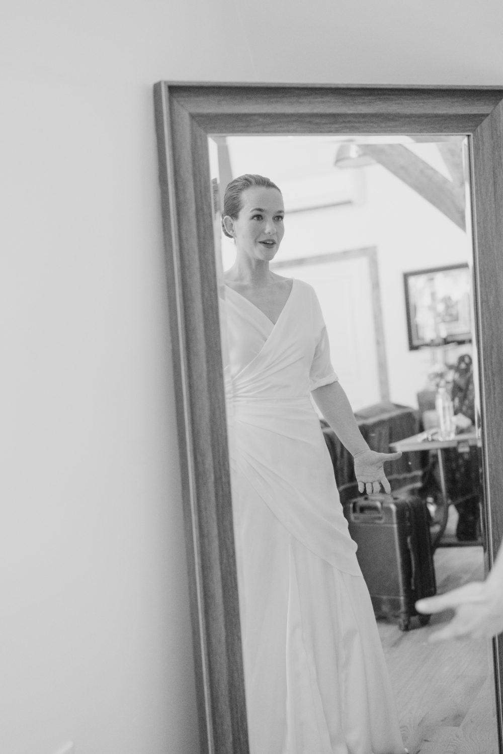 BRIDE STARES AT HERSELF IN A LENGTH SIZE MIRROR