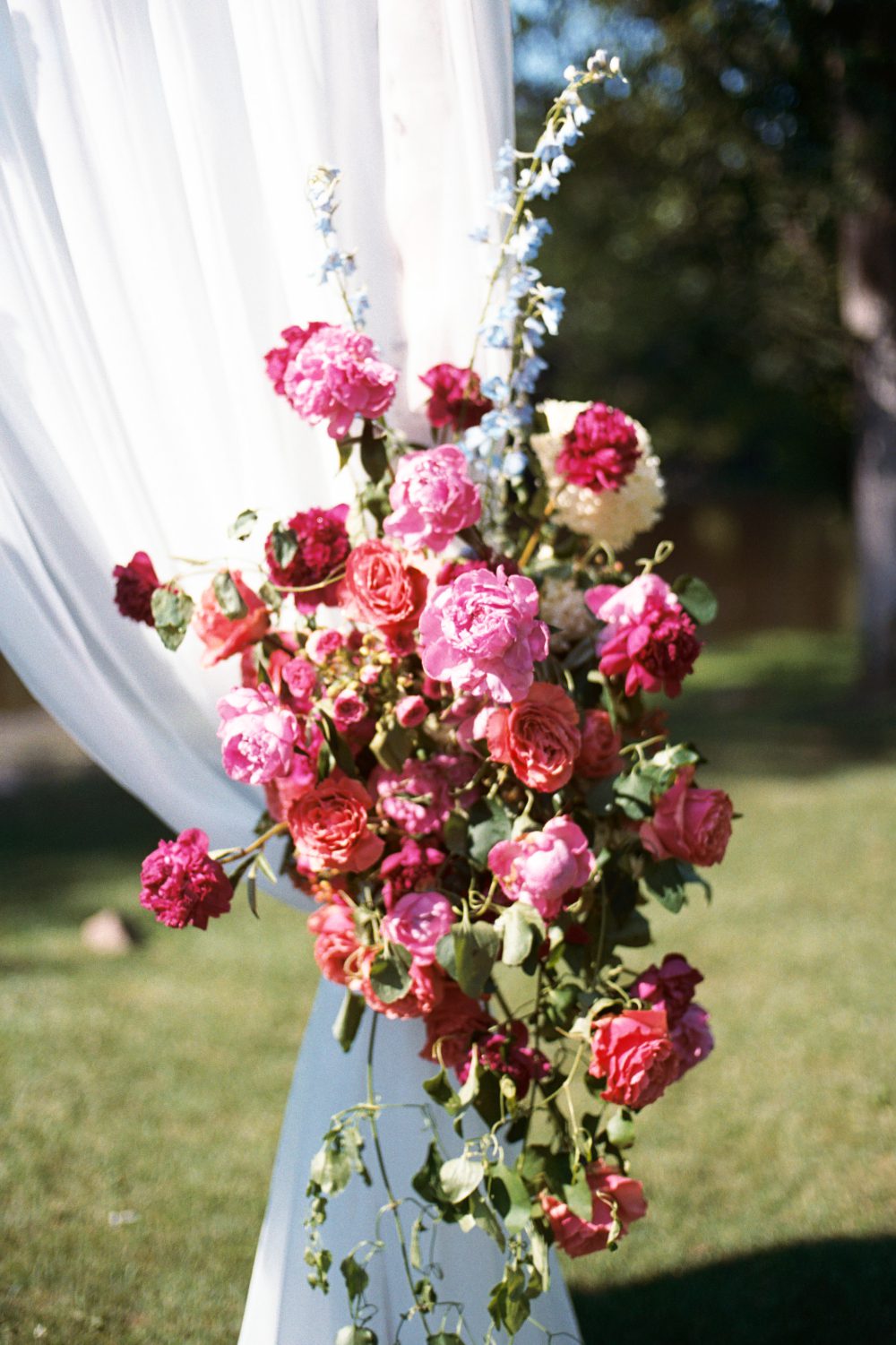 WHITE DRAPERY ARCH AND FLORALS