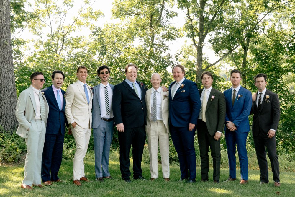 GROOM WITH GROOMSMEN FOR OUTDOOR WEDDING PORTRAITS WITH GROOMSMEN WEARING VERY DIFFERENT OUTFITS