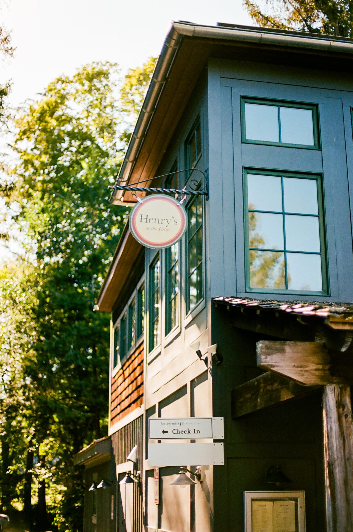 Exterior of Henry’s at the Farm at Buttermilk Falls with signage and rustic details, blending farm-to-table dining with the experience of destination weddings in Hudson Valley.